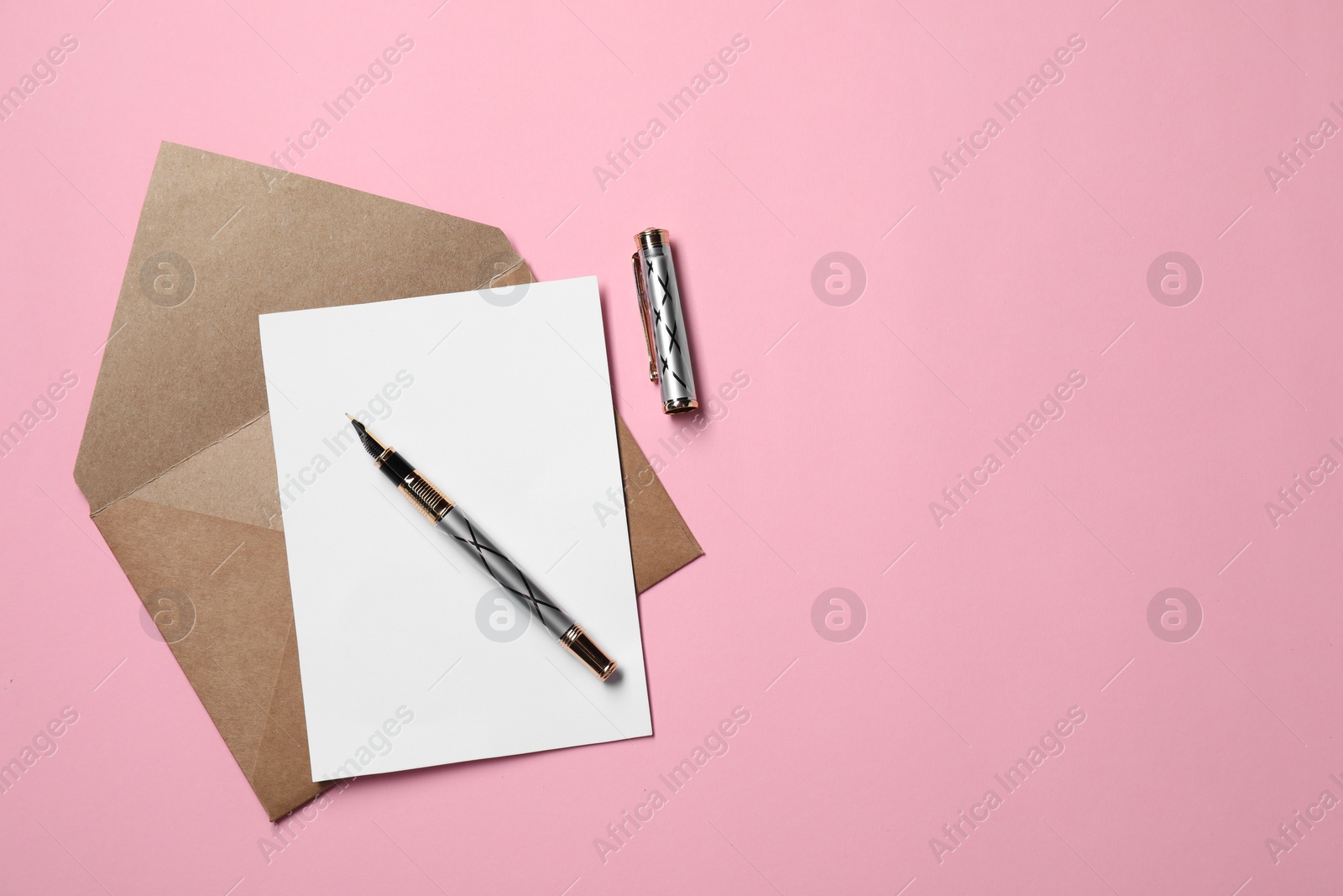 Photo of Blank sheet of paper, letter envelope and pen on pink background, top view. Space for text