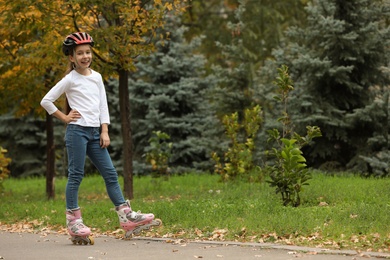 Photo of Cute girl roller skating in autumn park