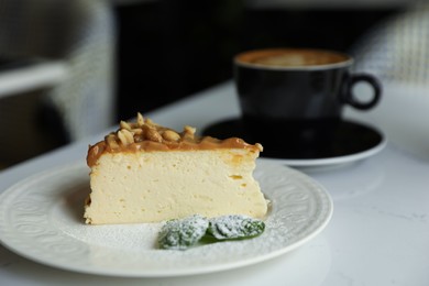 Tasty dessert and cup of fresh coffee on table indoors