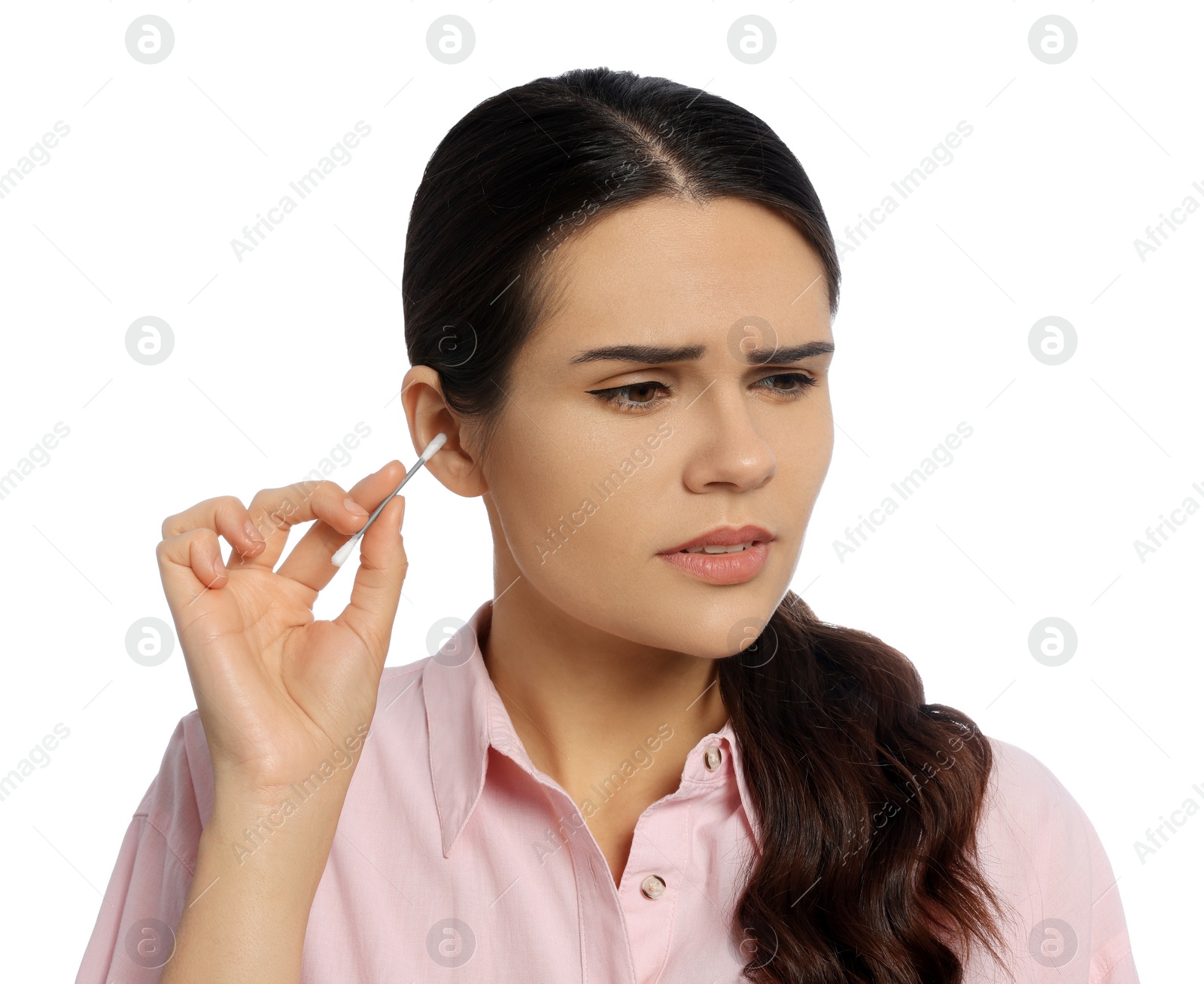 Photo of Young woman cleaning ear with cotton swab on white background