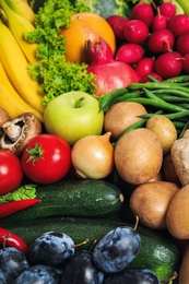 Assortment of fresh organic fruits and vegetables as background, closeup