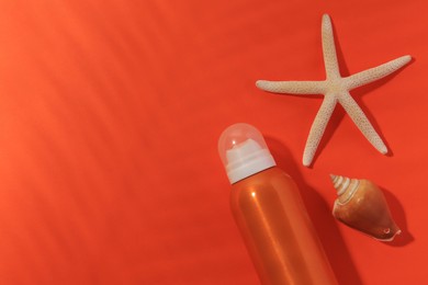 Photo of Sunscreen, seashell and starfish on coral background, flat lay and space for text. Sun protection care