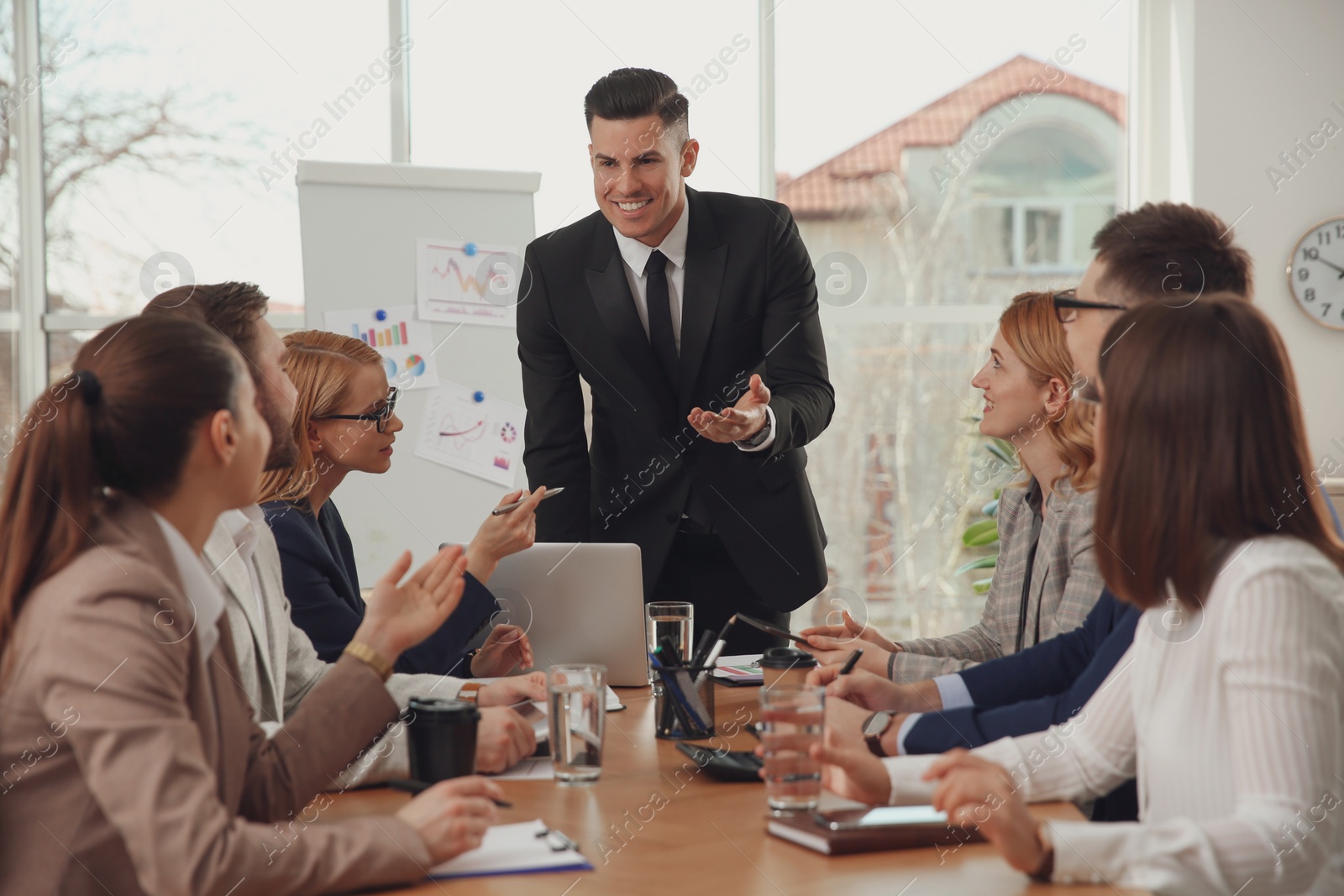 Photo of Businesspeople having meeting in office. Management consulting