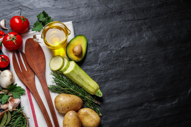 Flat lay composition with fresh products on grey table, space for text. Healthy cooking