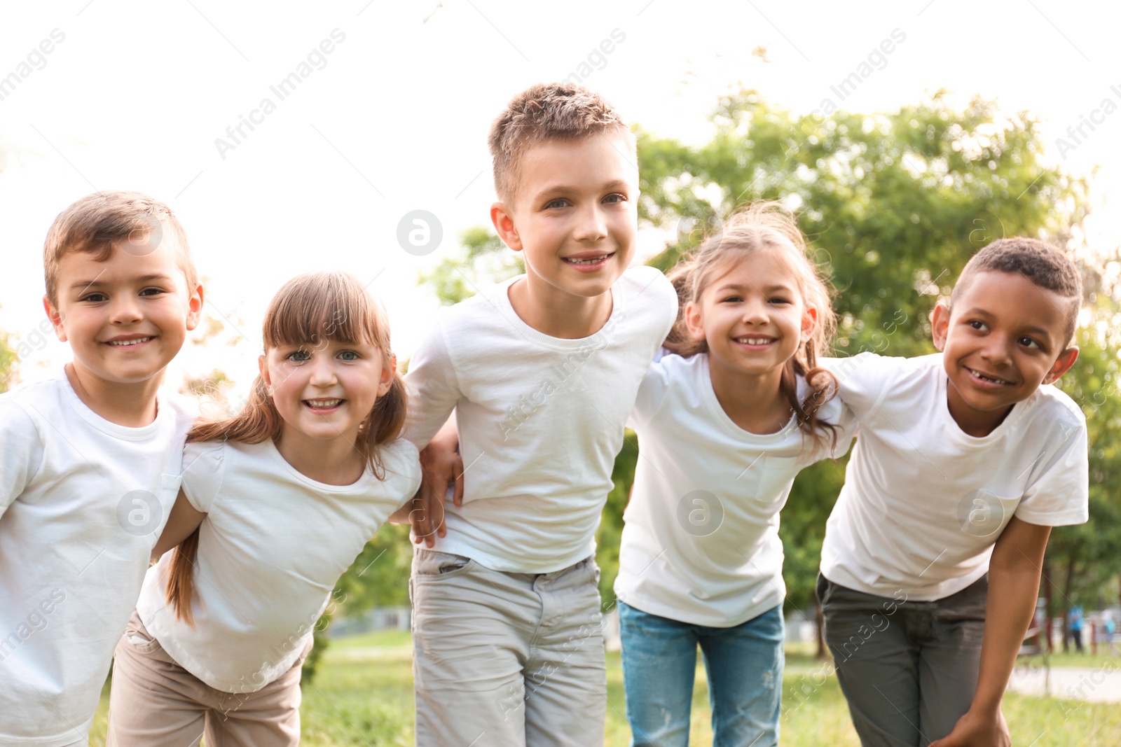 Photo of Group of children huddling in park. Volunteer project