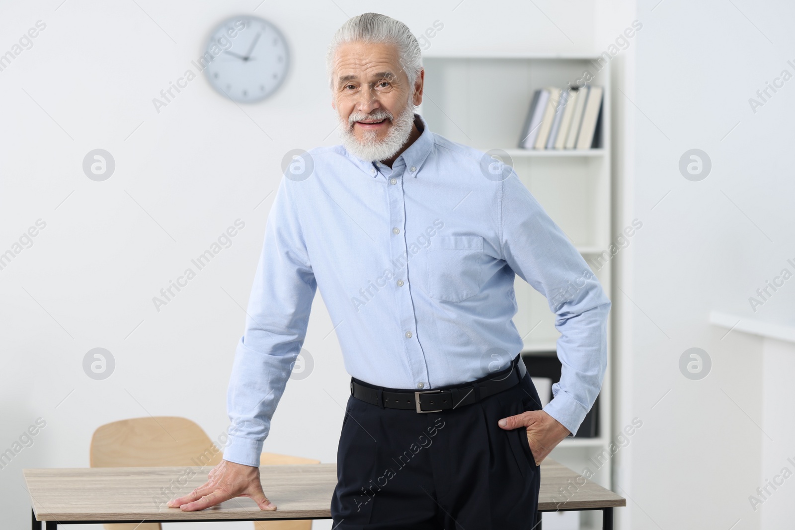 Photo of Portrait of handsome senior man in office