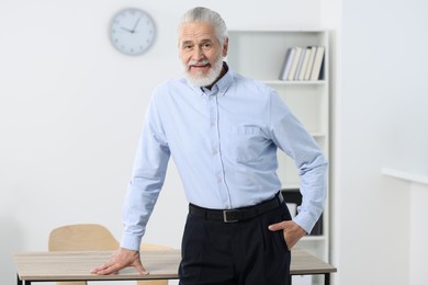 Portrait of handsome senior man in office