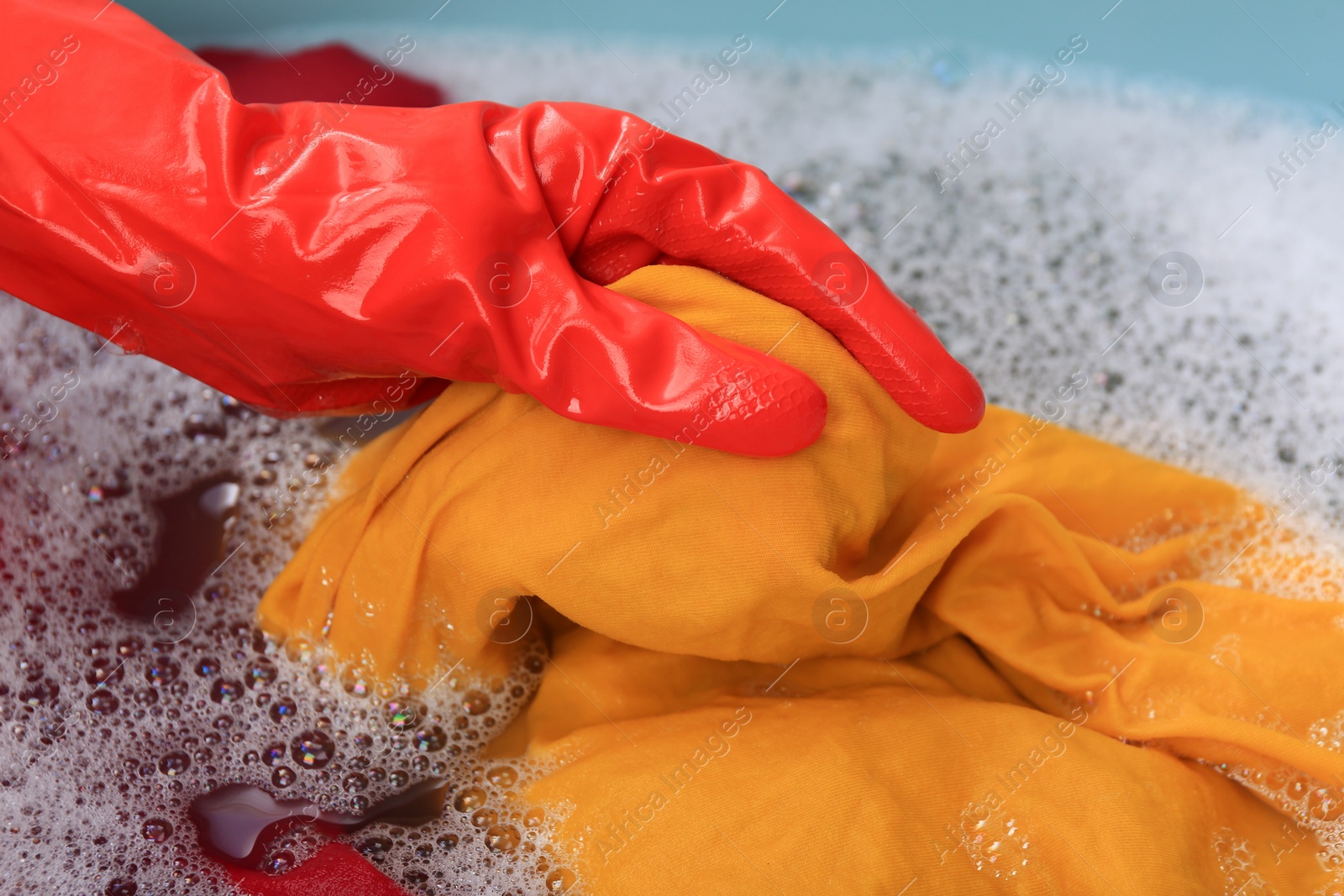 Photo of Woman washing garment in basin, closeup. Laundry