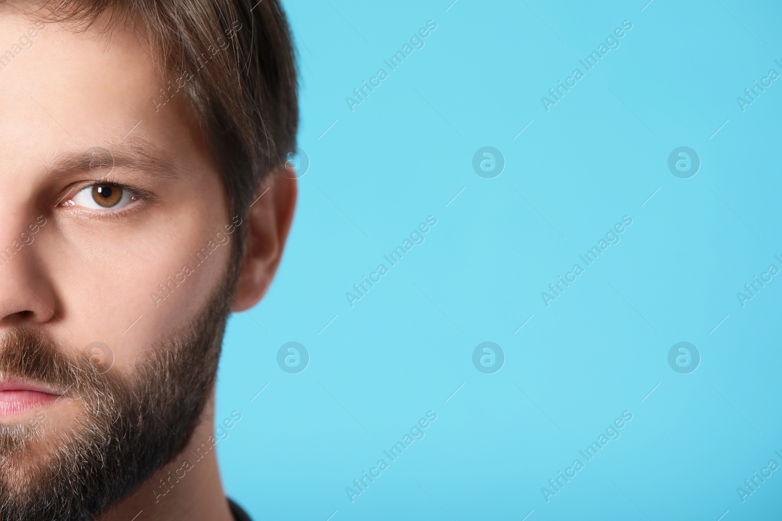 Photo of Doctor or medical assistant (male nurse) on turquoise background, closeup. Space for text