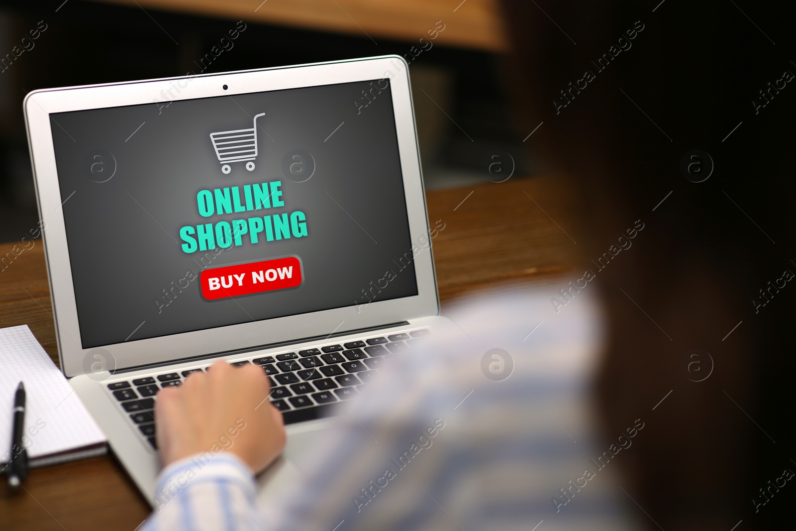 Image of Woman using laptop for online shopping at table, closeup