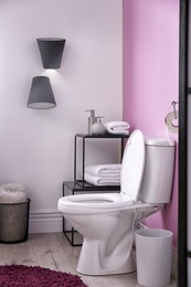 Toilet bowl in modern bathroom interior