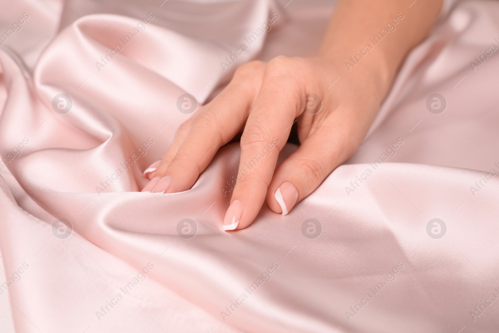 Photo of Woman touching smooth silky fabric, closeup view