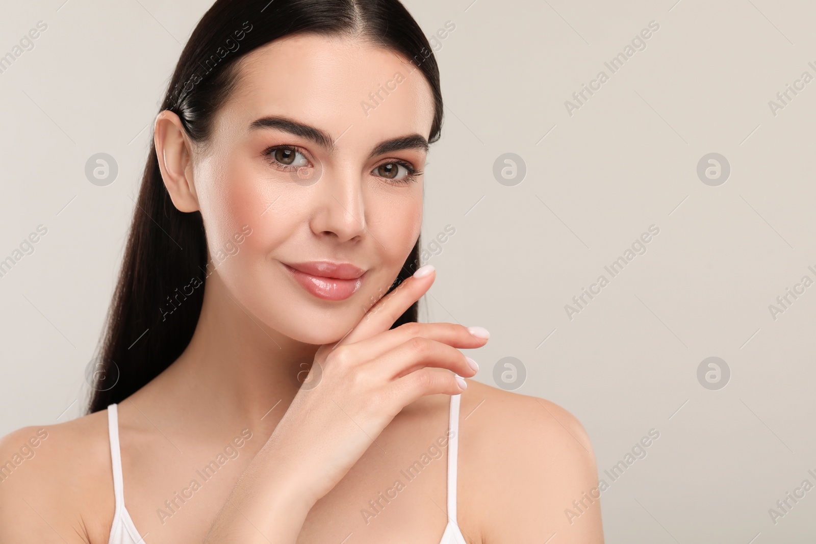 Photo of Beautiful woman with healthy skin on gray background, space for text