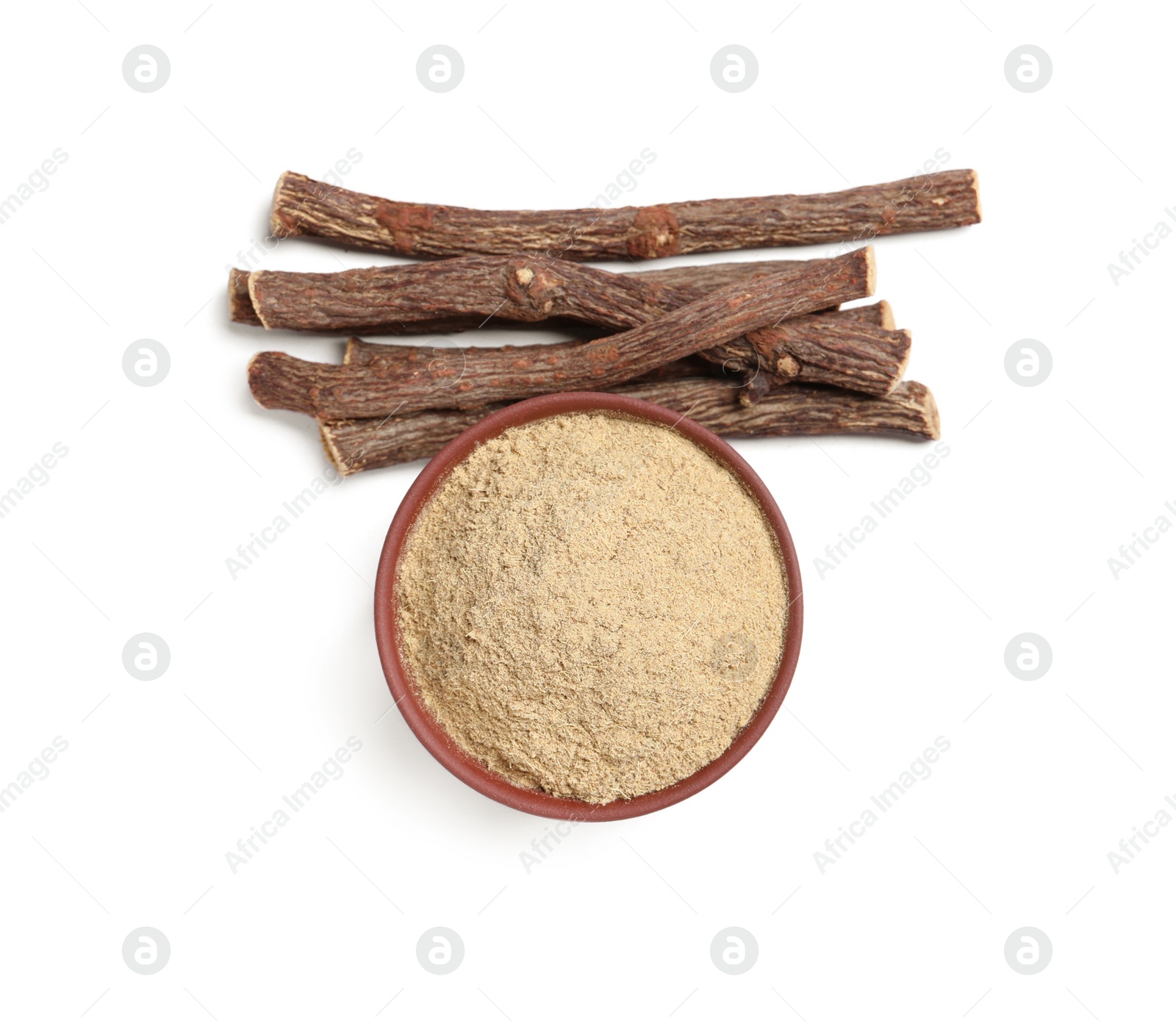 Photo of Powder in bowl and dried sticks of liquorice root on white background, top view