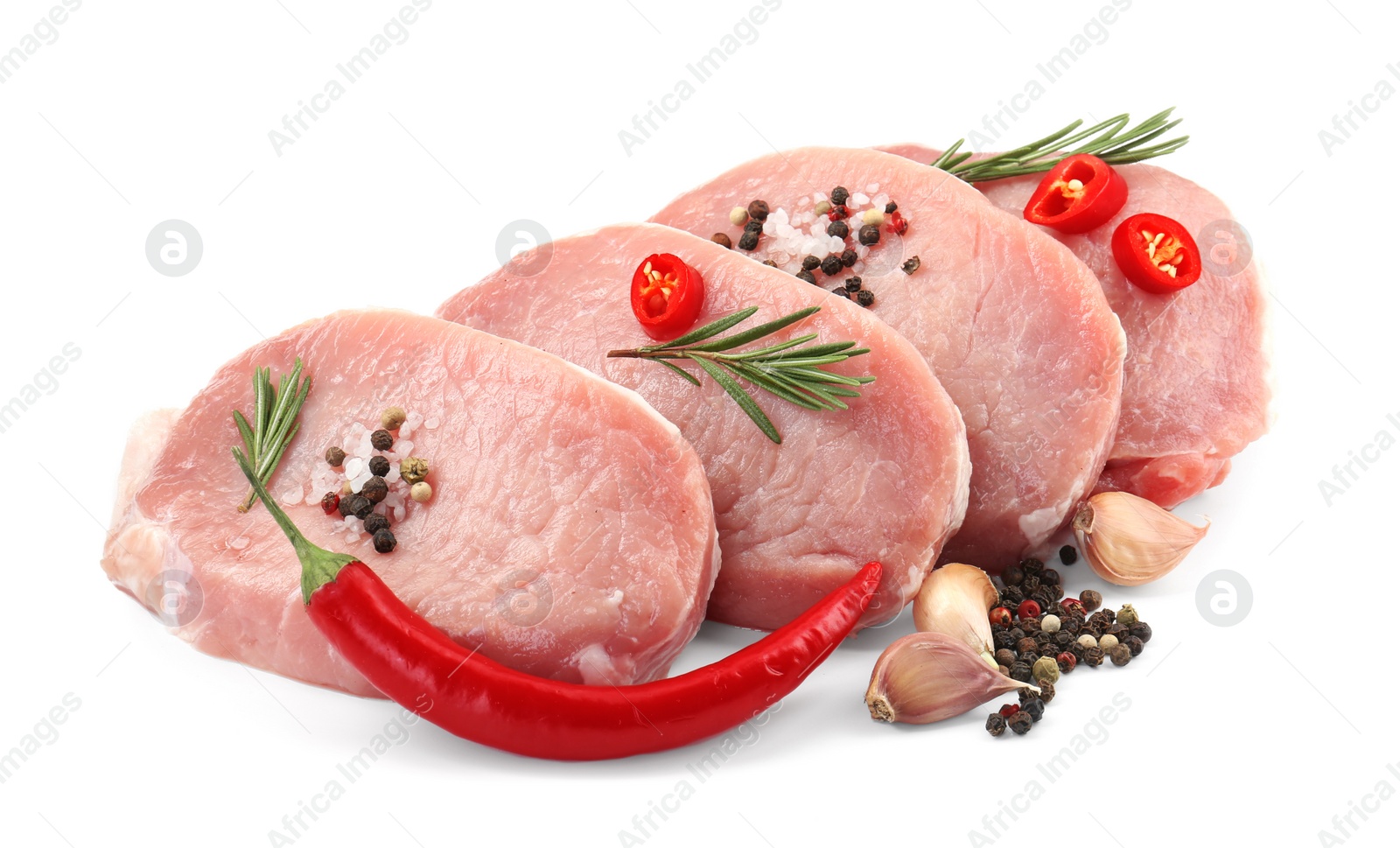 Photo of Pieces of raw pork meat, chili peppers and spices isolated on white