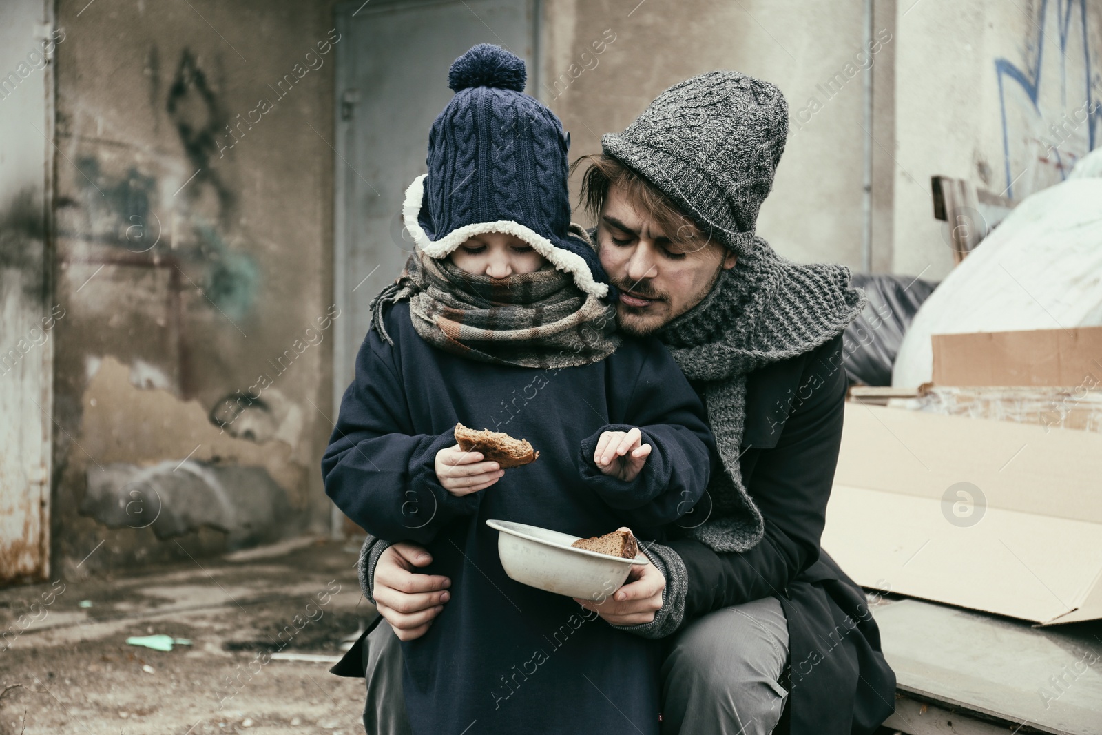 Photo of Poor father and child with bread at dump