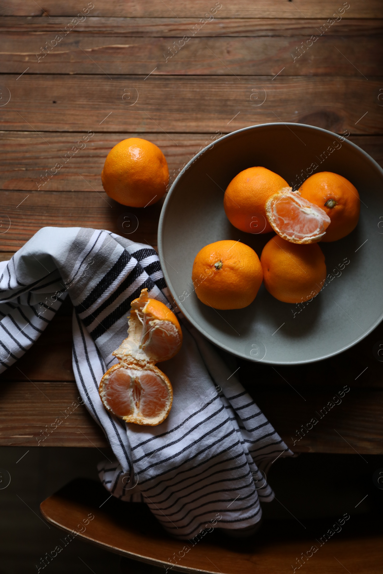 Photo of Fresh ripe tangerines on wooden table, flat lay