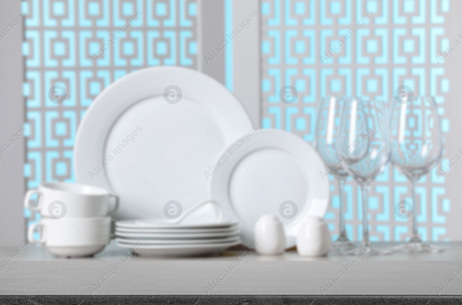 Image of Set of clean dishware, focus on empty stone table