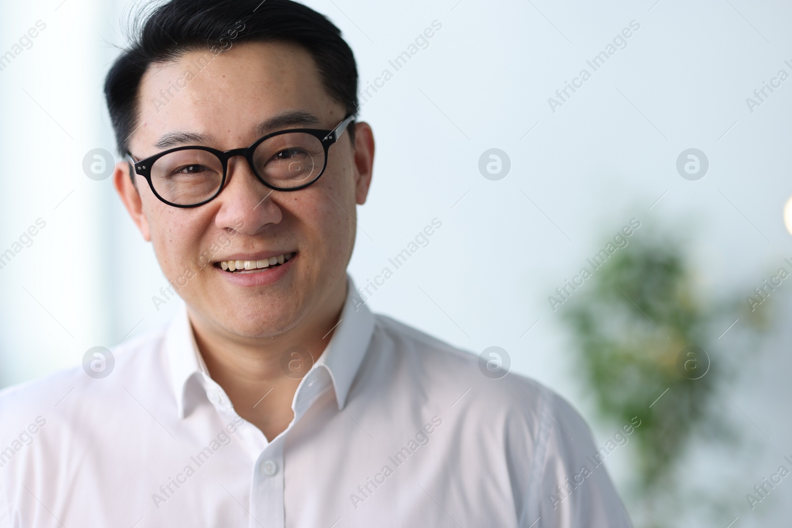 Photo of Portrait of smiling businessman in office. Space for text