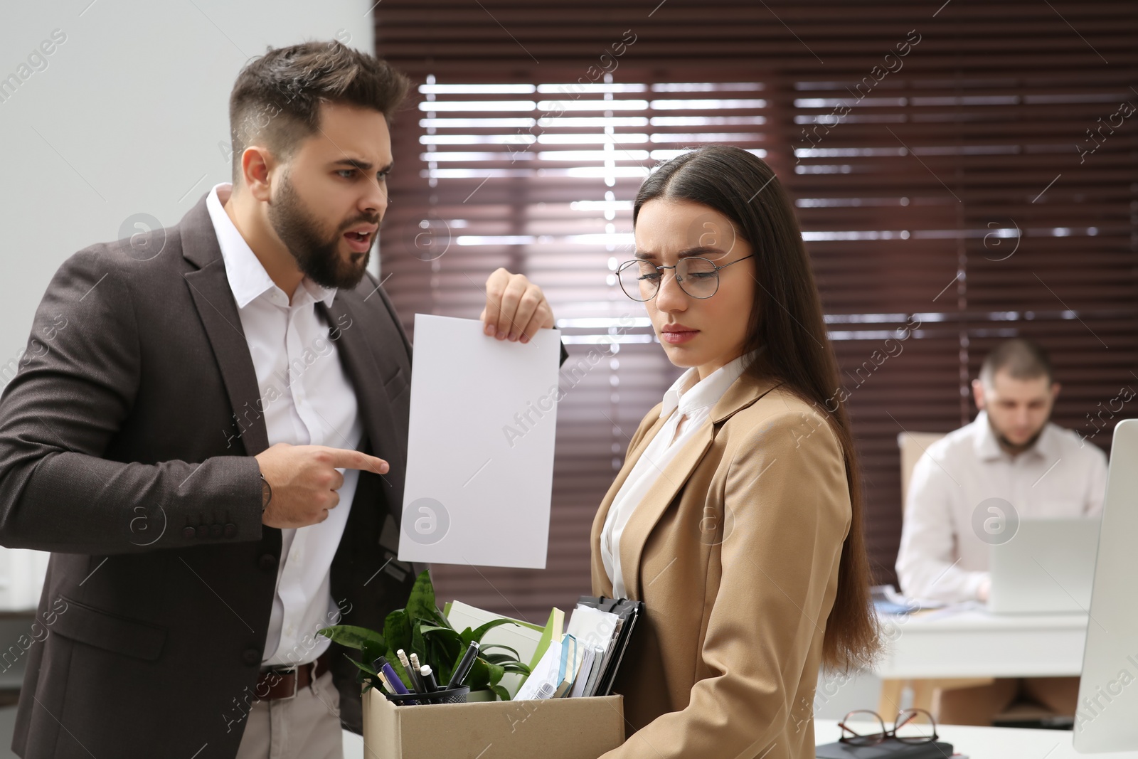 Photo of Boss dismissing young woman from work in office