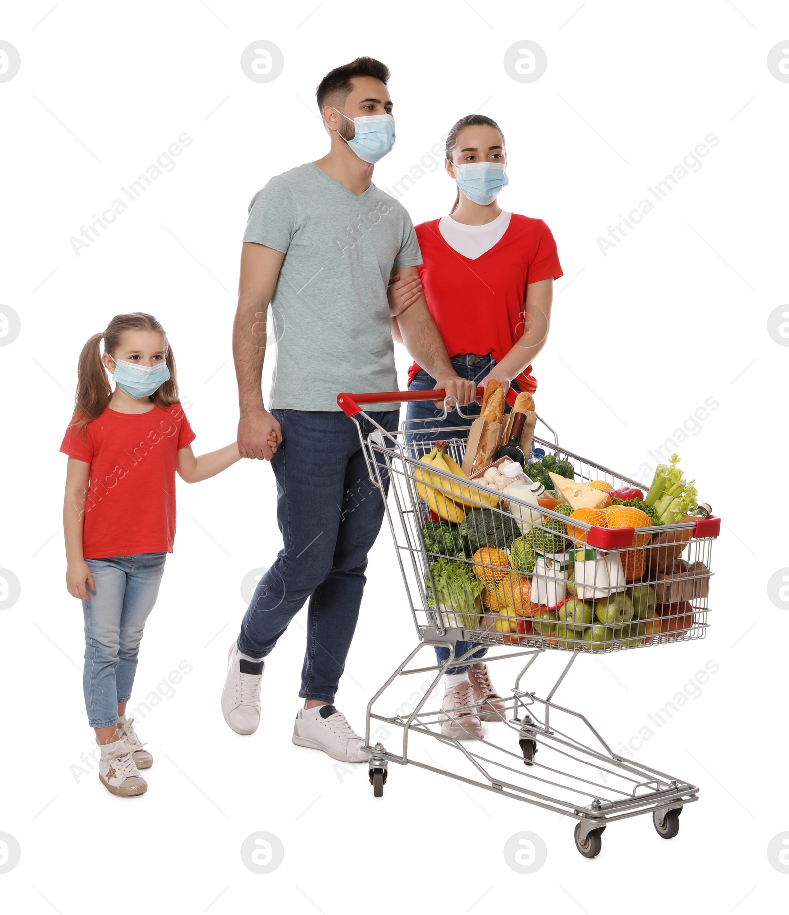 Photo of Family with protective masks and shopping cart full of groceries on white background