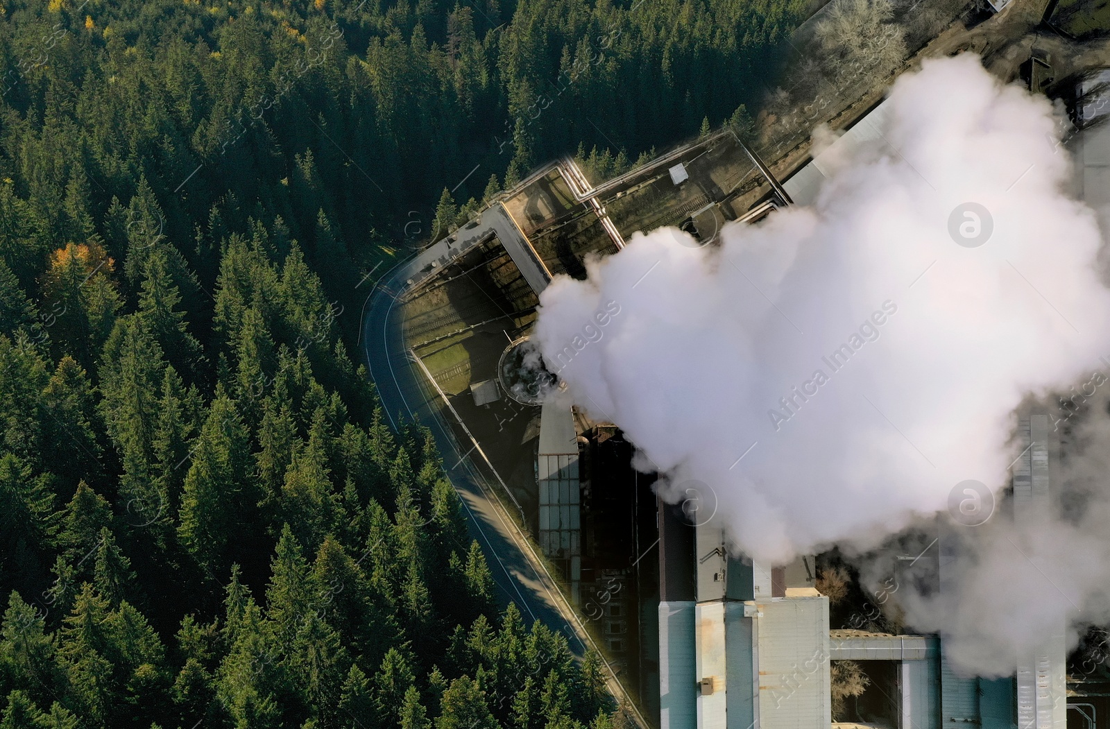 Image of Environmental pollution. Collage divided into dense forest and industrial factory with emissions, double exposure