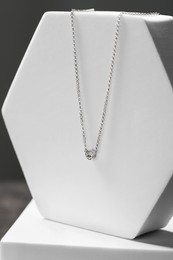 Beautiful necklace with gemstone on white podium. Luxury jewelry