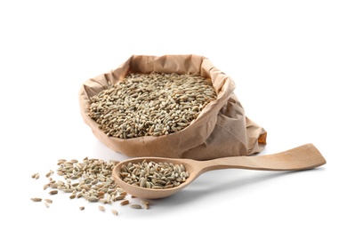 Photo of Paper bag and spoon with raw rye on white background. Healthy grains and cereals