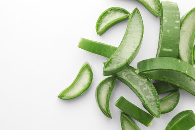 Fresh aloe vera pieces on white background, flat lay. Space for text