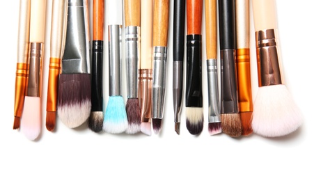 Makeup brushes of professional artist on white background