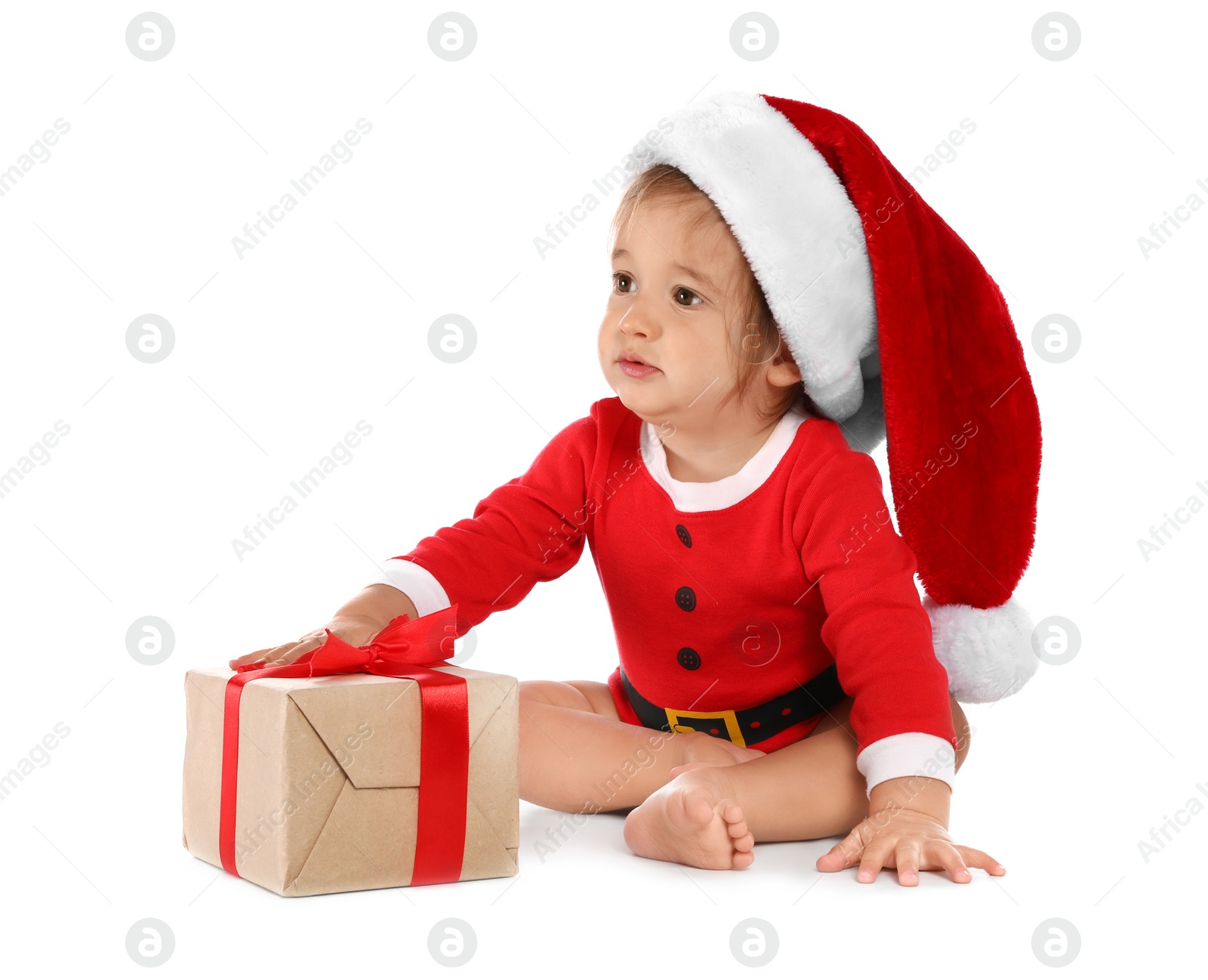 Photo of Festively dressed baby with gift box on white background. Christmas celebration