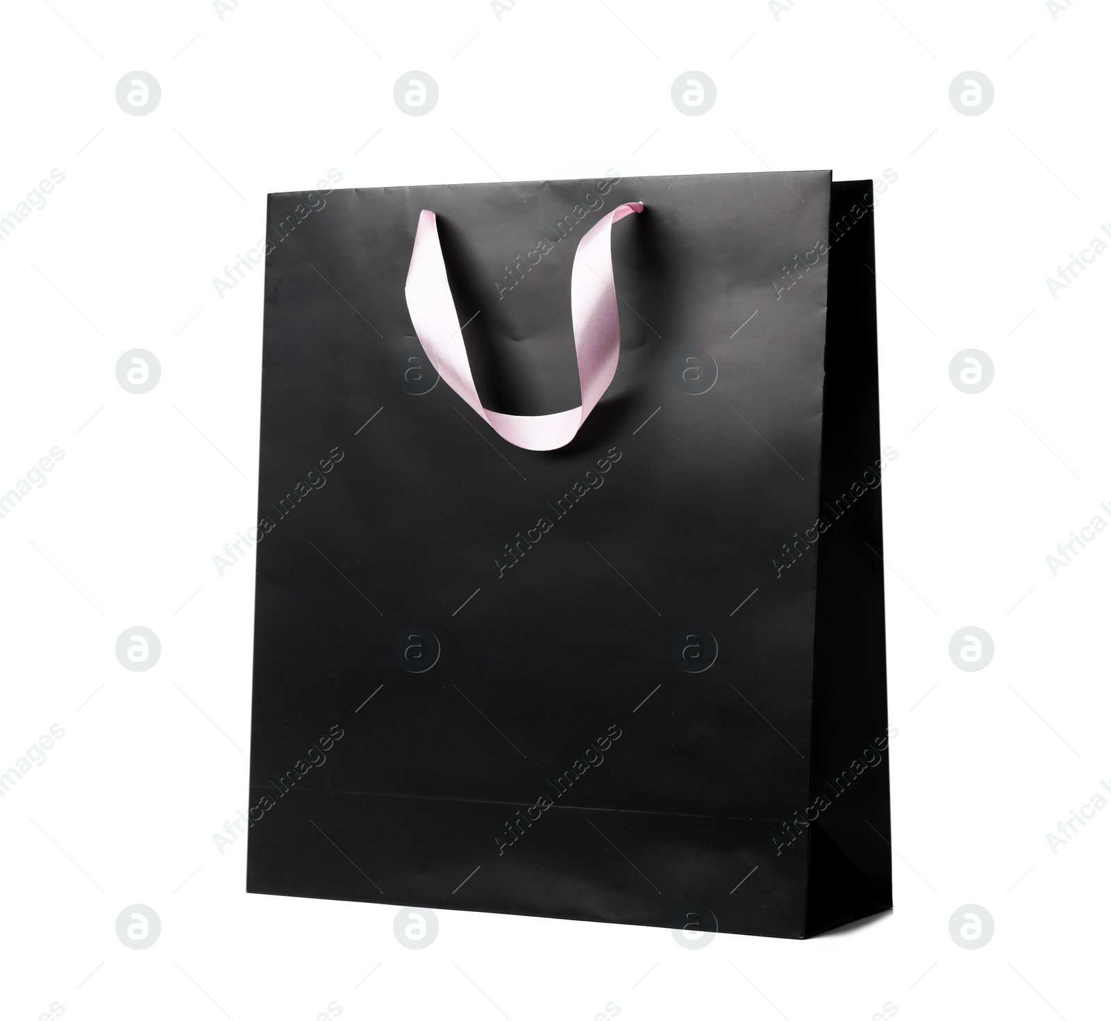 Photo of Paper shopping bag with ribbon handles on white background. Mockup for design