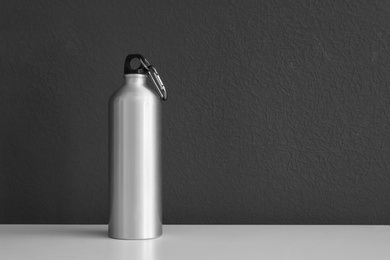 Photo of Aluminum water bottle for sports on gray background. Space for text