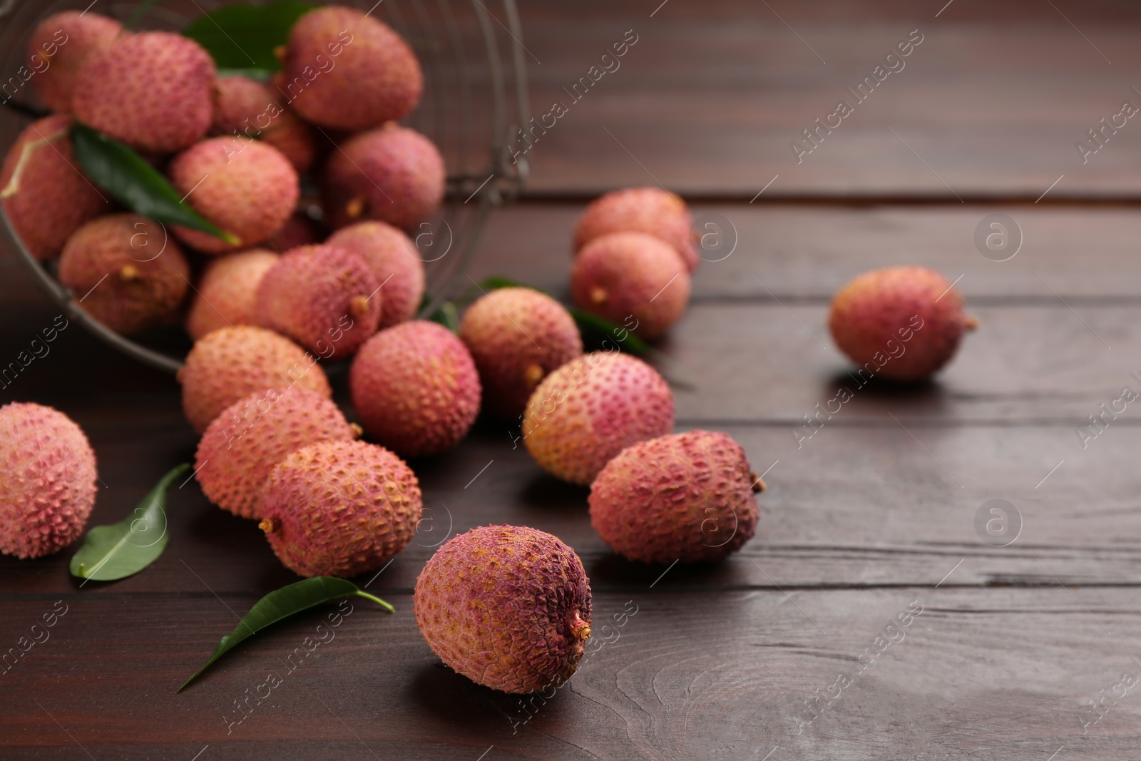 Photo of Fresh ripe lychee fruits on wooden table