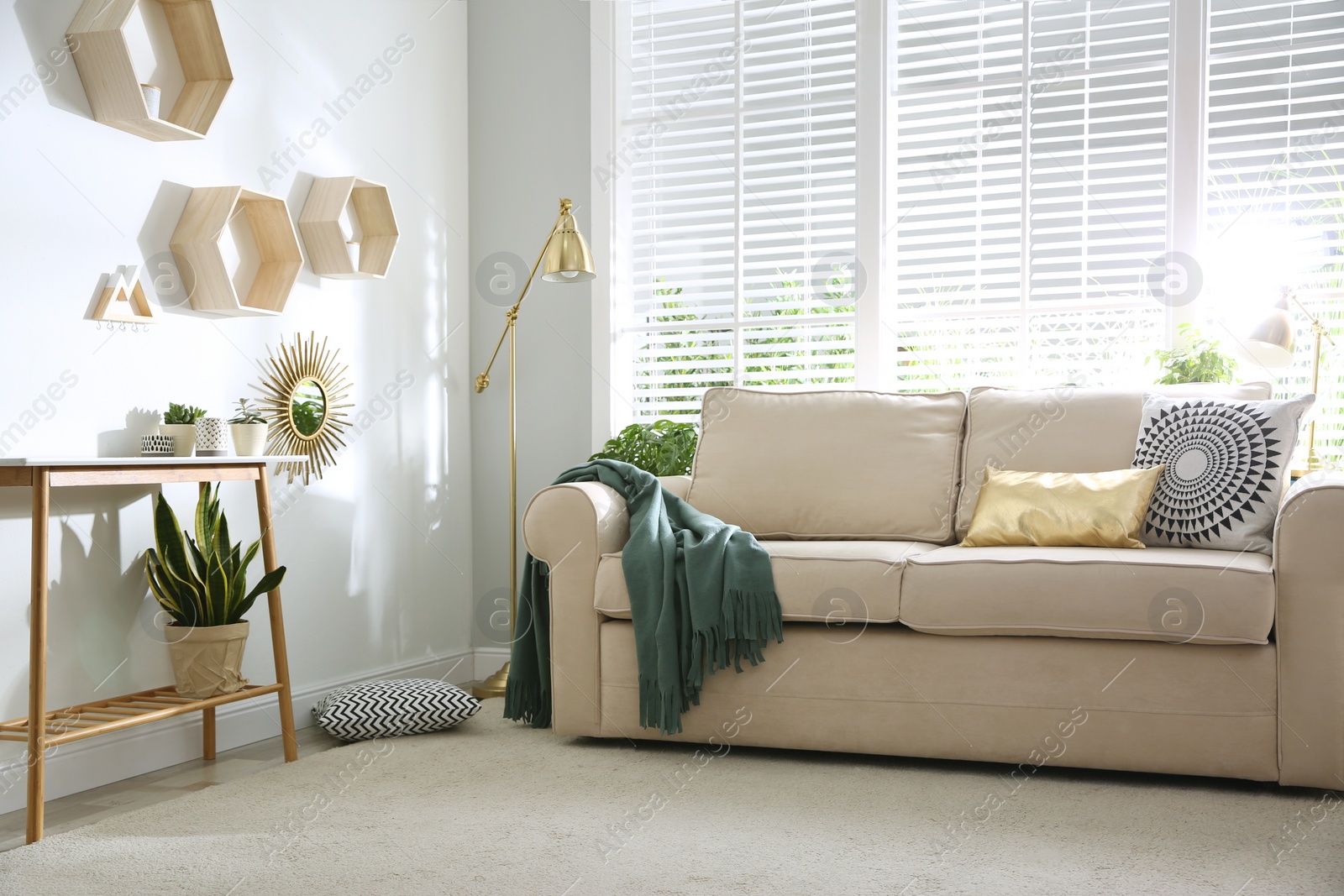 Photo of Stylish beige sofa in modern living room interior