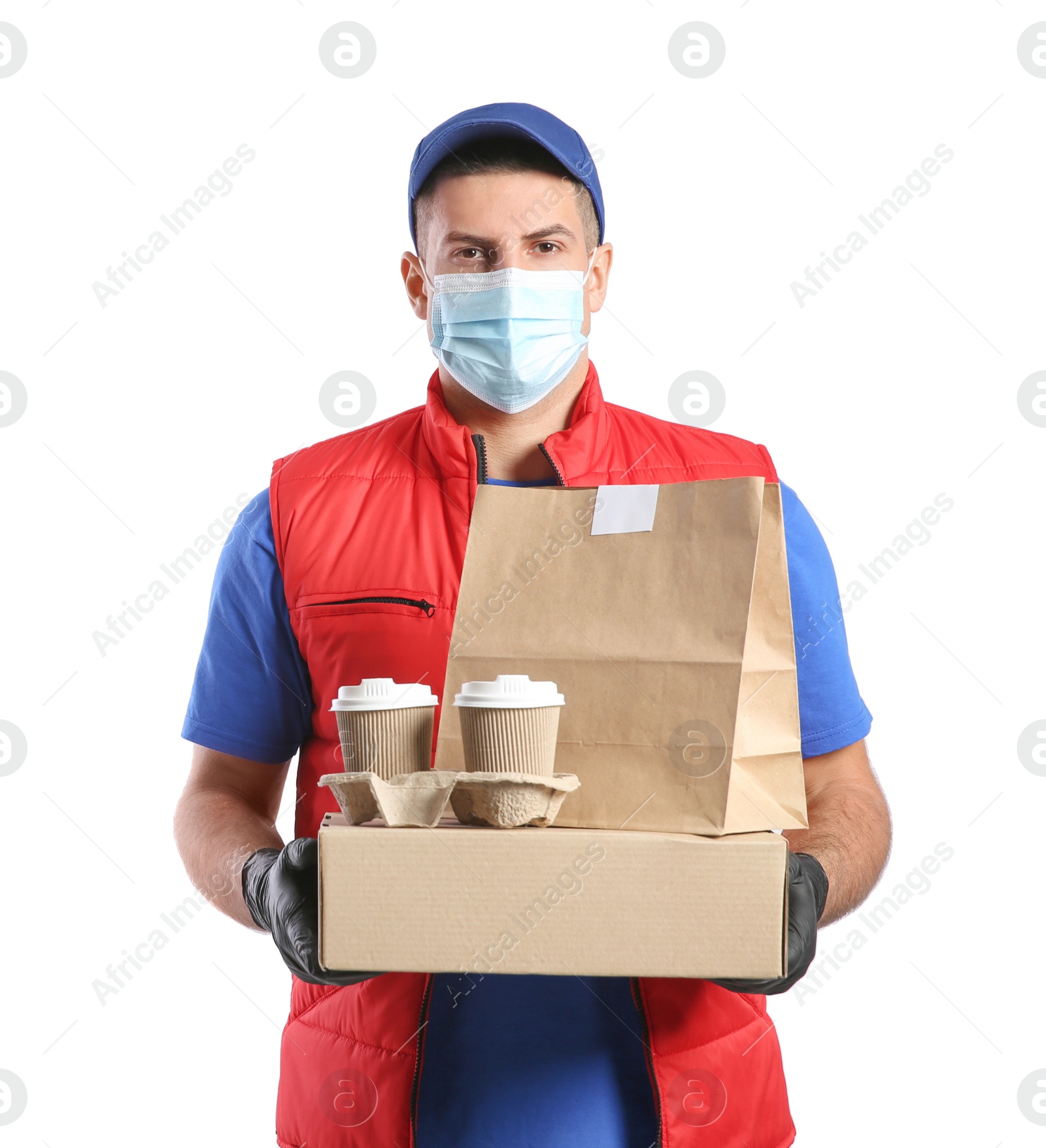 Photo of Courier in medical mask holding packages with takeaway food and drinks on white background. Delivery service during quarantine due to Covid-19 outbreak