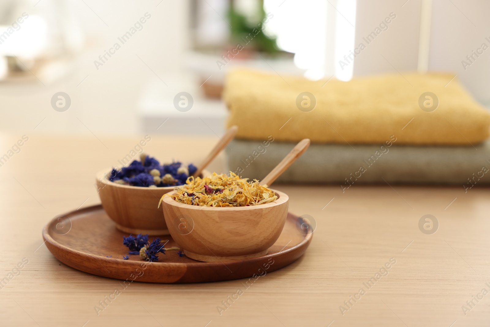 Photo of Dry flowers on wooden table indoors, space for text. Spa time