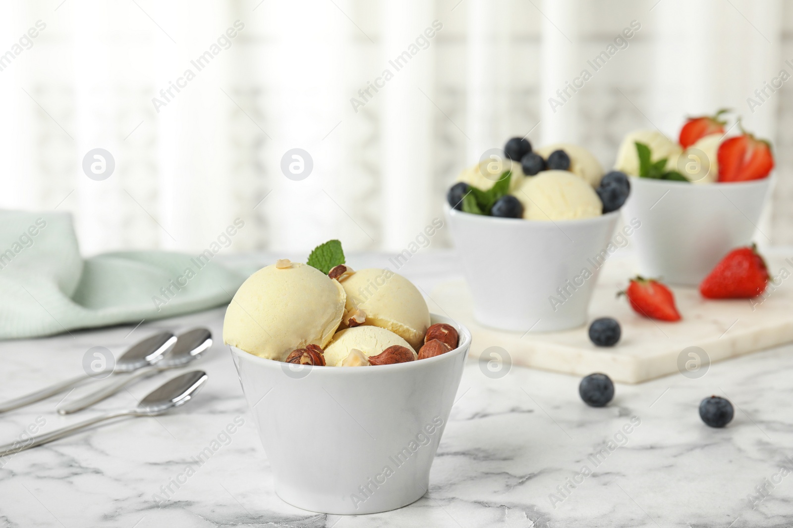 Photo of Delicious vanilla ice cream served on marble table. Space for text