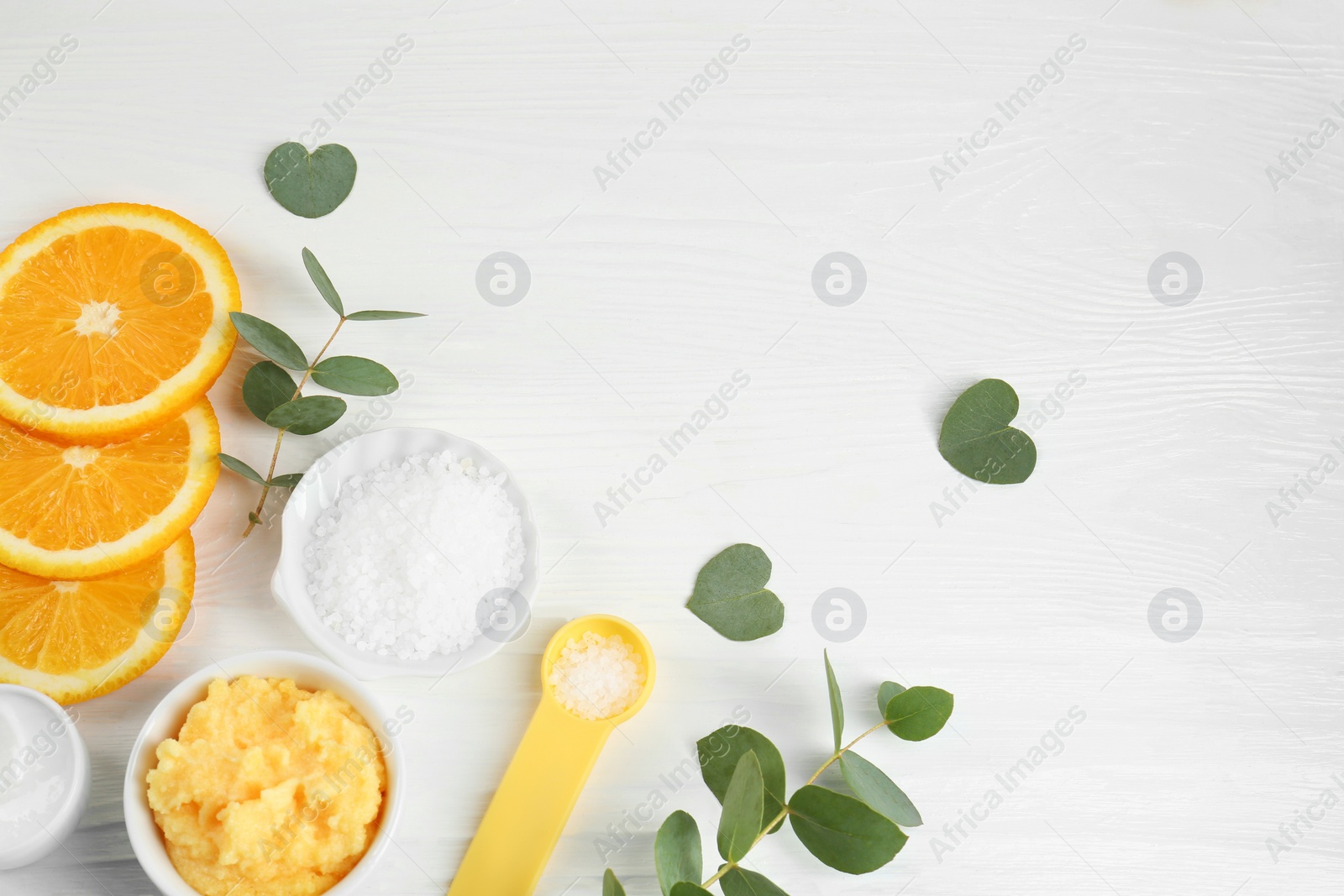 Photo of Homemade cosmetic products and fresh ingredients on white wooden table, flat lay. Space for text