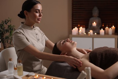 Photo of Spa therapy. Beautiful young woman lying on table during massage in salon