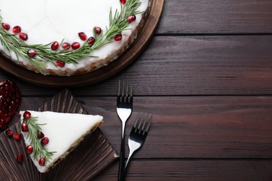 Traditional homemade Christmas cake served on wooden table, flat lay. Space for text