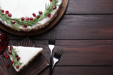 Photo of Traditional homemade Christmas cake served on wooden table, flat lay. Space for text