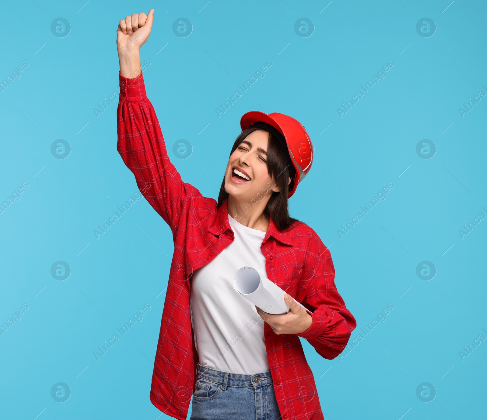 Photo of Architect in hard hat with draft on light blue background