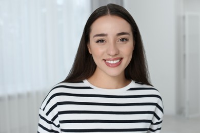 Portrait of beautiful young woman at home