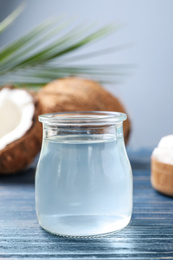 Coconut oil on blue wooden table, closeup view