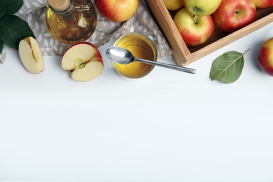 Photo of Natural apple vinegar and fresh fruits on white wooden table, flat lay. Space for text