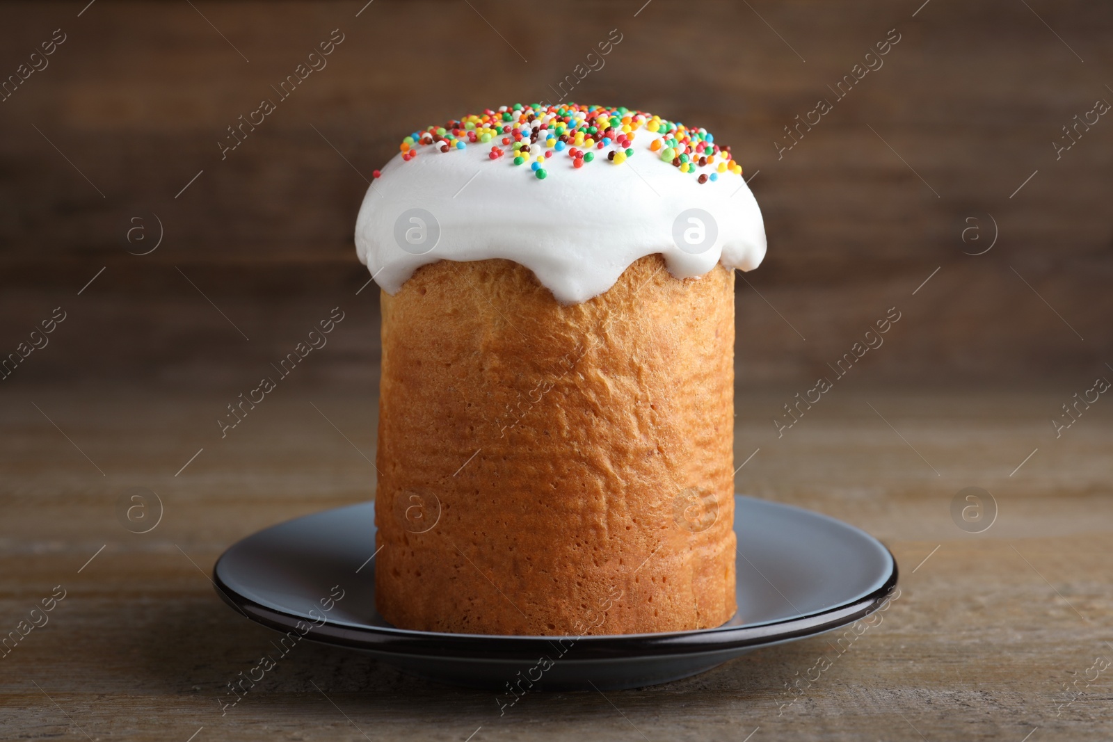 Photo of Traditional decorated Easter cake on wooden table