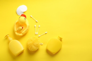 Photo of Flat lay composition with baby cosmetic products on yellow background. Space for text