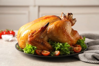 Photo of Platter of cooked turkey with garnish on table