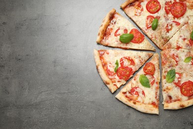 Delicious pizza Margherita on grey table, flat lay. Space for text